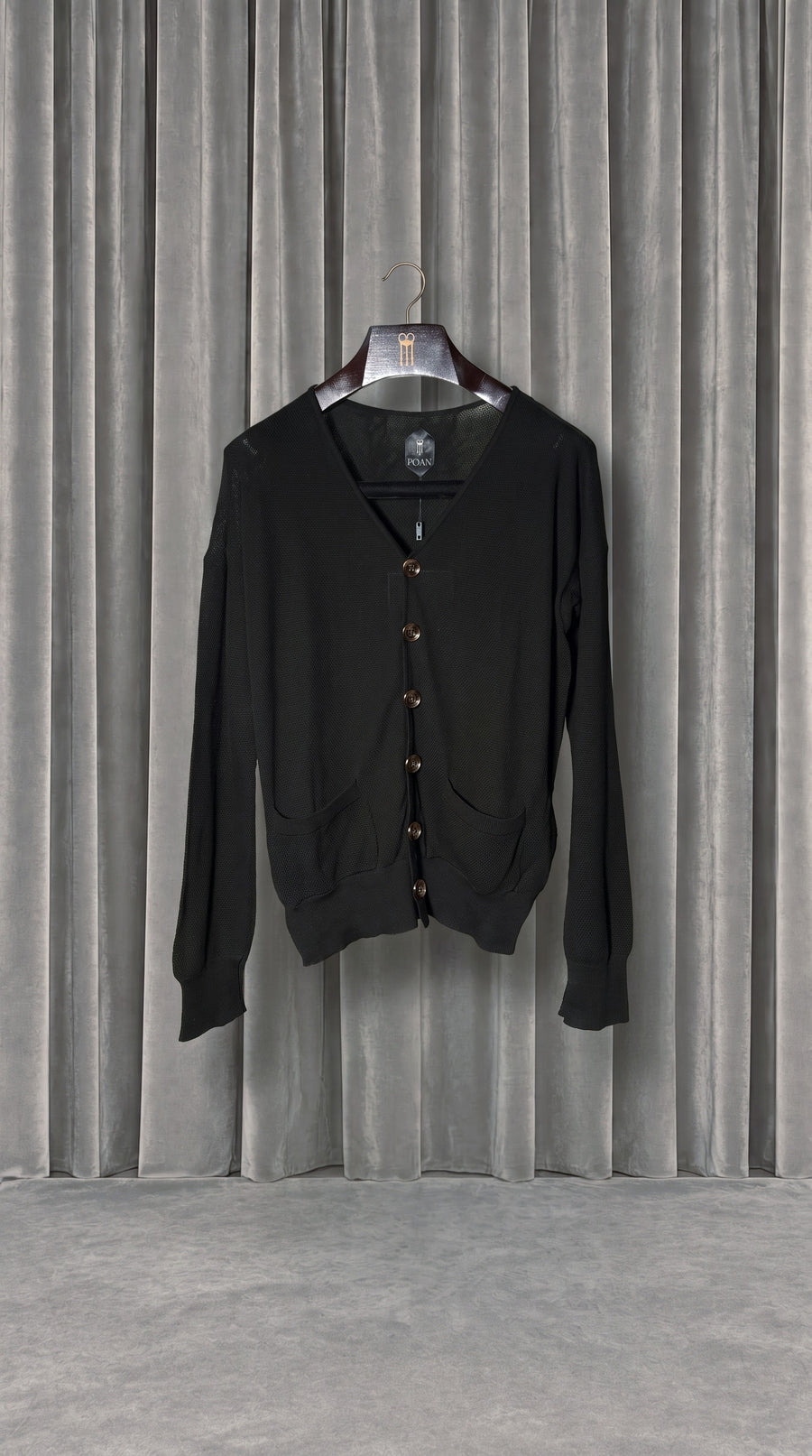 Roberto Cardigan Women Black – product on hanger in front of the grey velvet curtain