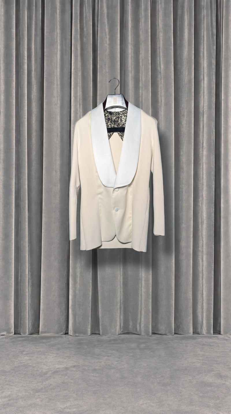 Smoker Jacket Women Ivory – product on hanger in front of the grey velvet curtain