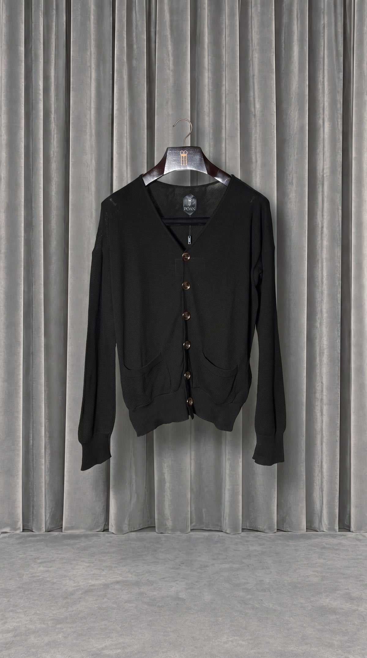 Roberto Cardigan Women Black – product on hanger in front of the grey velvet curtain