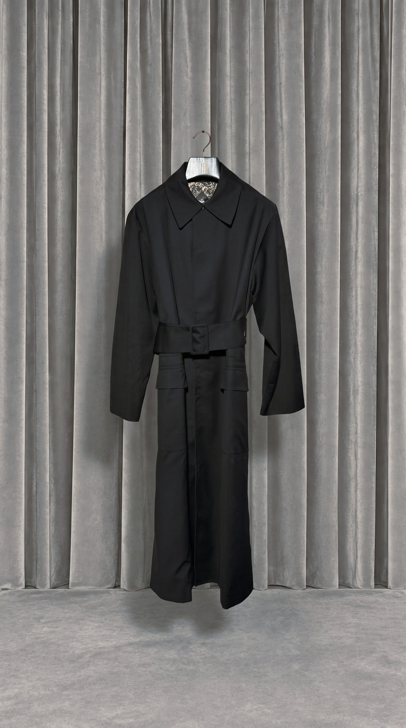 Victor Overcoat Men Black – product on hanger in front of the grey velvet curtain